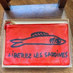 Clare V. Flat Clutch in Poppy Nappa & Navy Sardines Print.